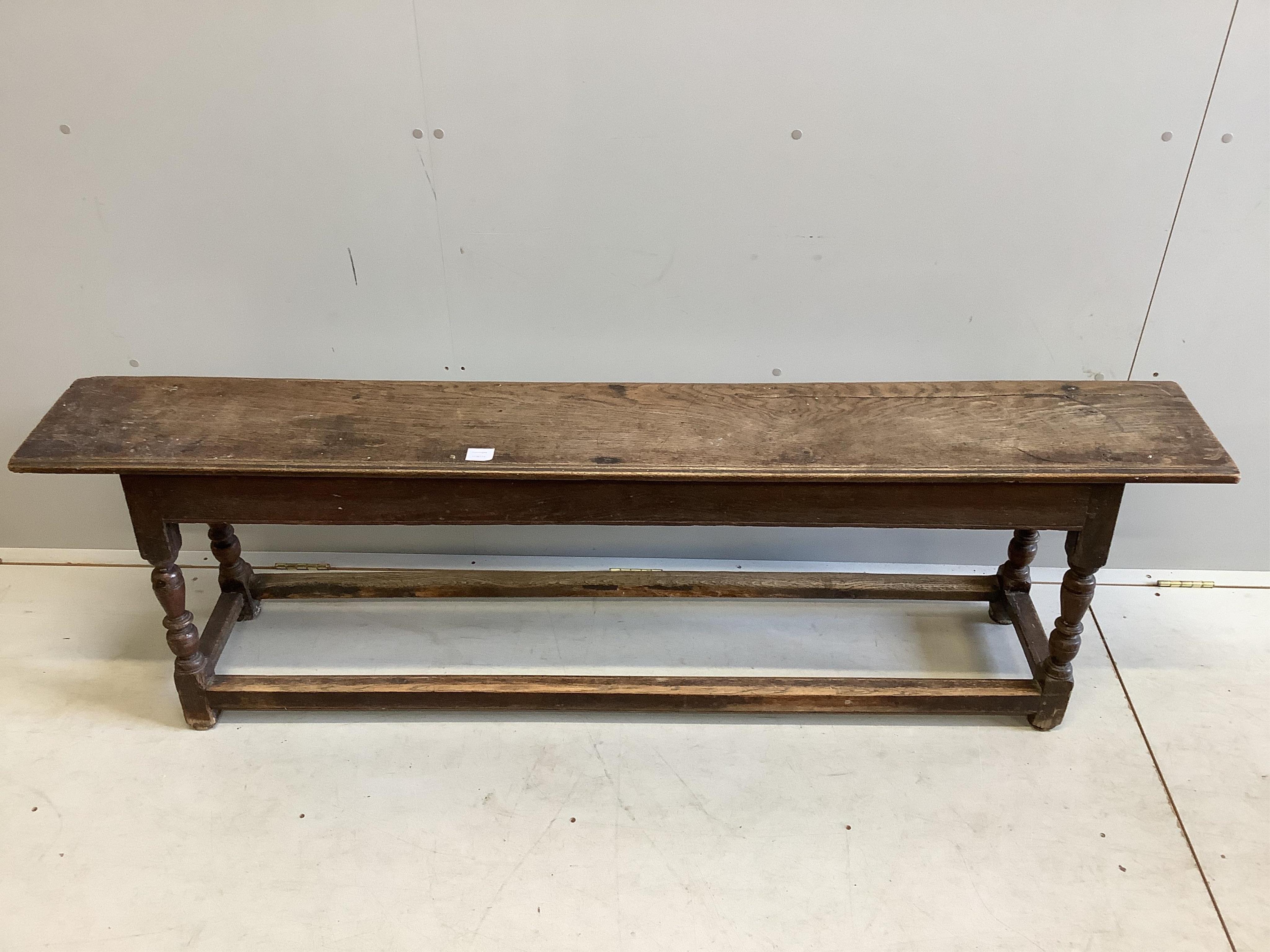 A 17th century style oak bench seat, width 181cm, depth 27cm, height 54cm. Condition - fair